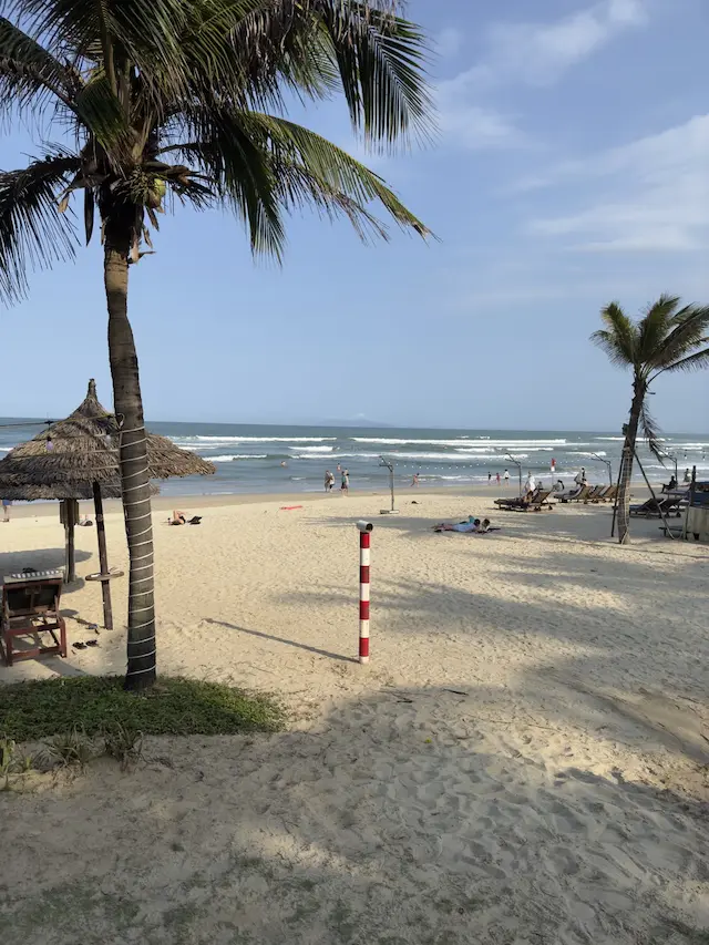 Palm trees and beach huts on My Khe Beach in Da Nang, February 16, 2025