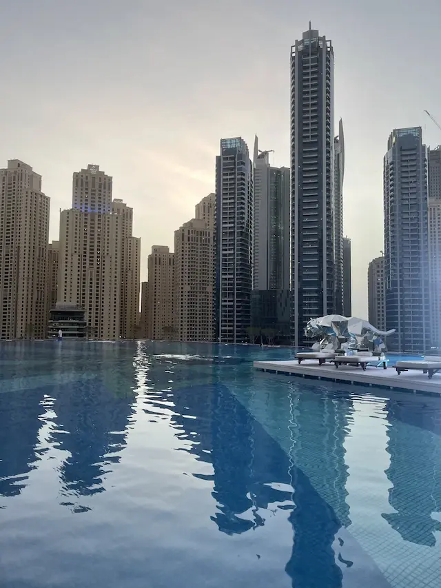 Towers reflected in a pool in Dubai, July 8, 2021
