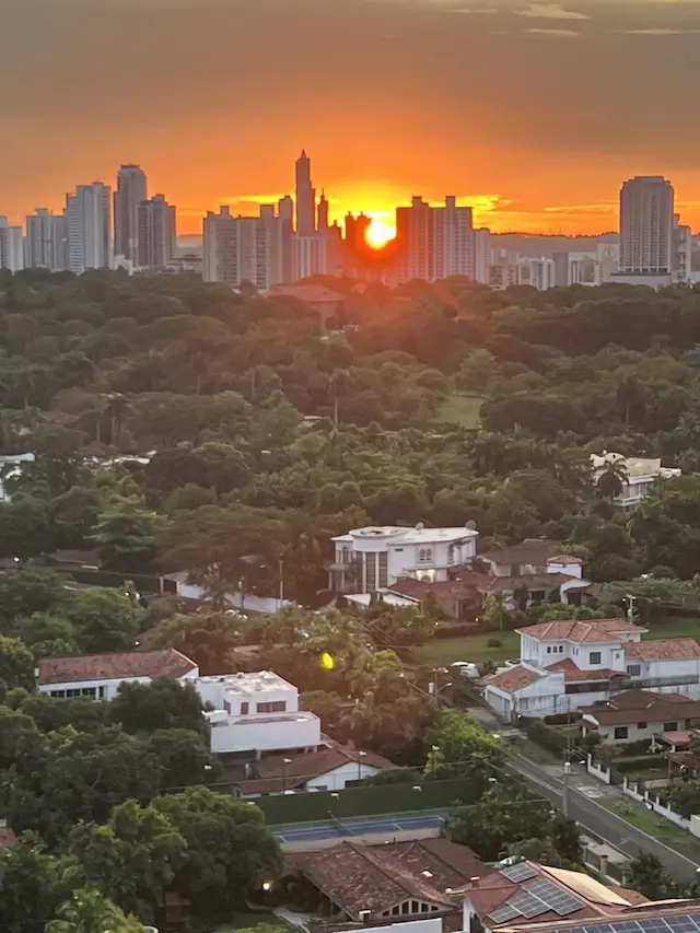 The sun setting between Panama City's towers, August 28, 2023