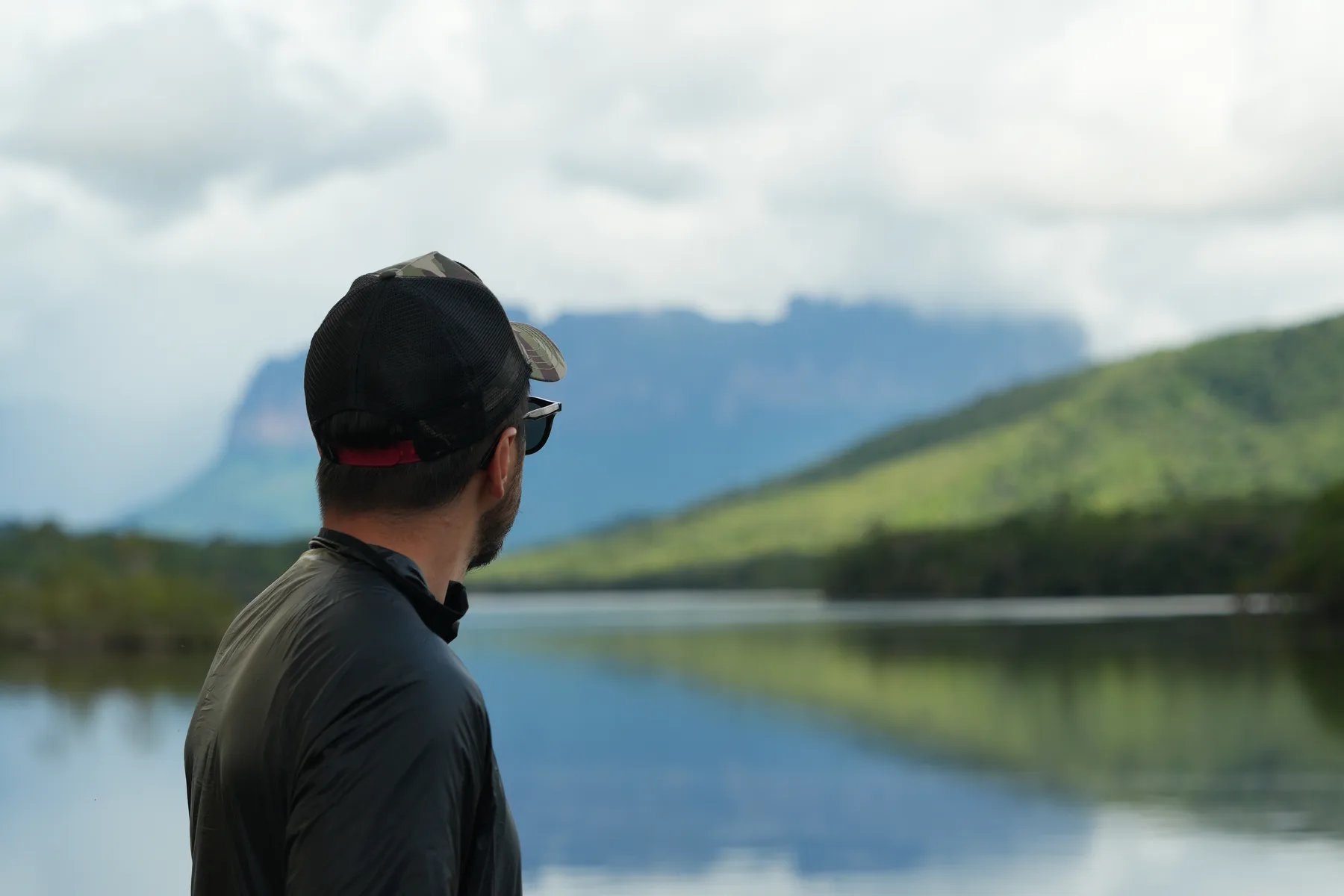 Navid Moazzez looking across a lagoon at a tepui in Canaima National Park, Venezuela
