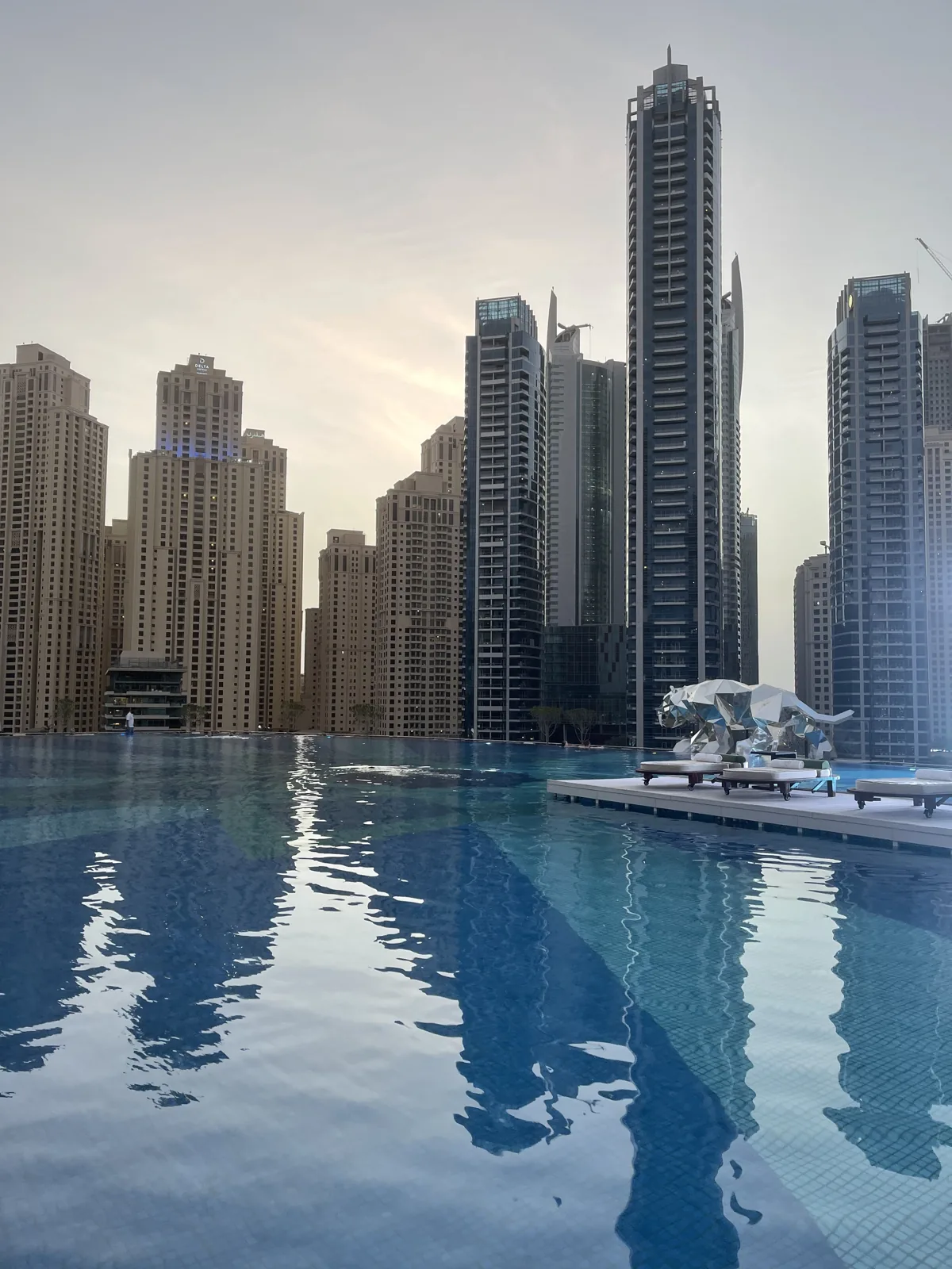 Towers reflected in a pool in Dubai, July 8, 2021